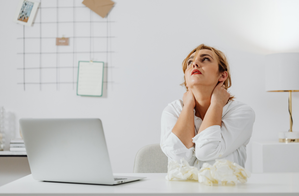 High-performing employee working late in empty office, depicting the hidden burnout risk of top performers